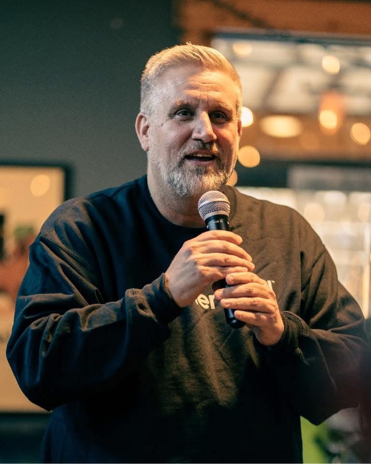 Alex Yeater, president of EvergreenAI, smiling and speaking into a microphone